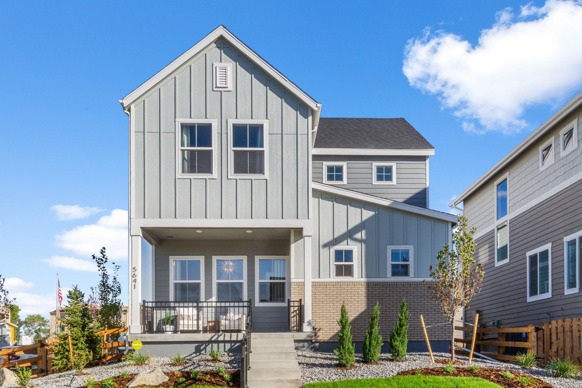 Contemporary Gray Home with Gable Roof in Dillon Pointe