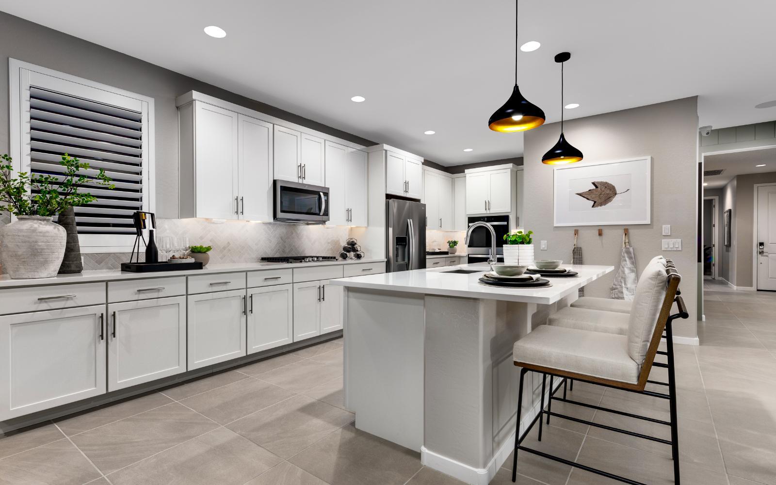Kitchen:An image of the kitchen in the Lily model home at Mariposa in Blossom Rock.