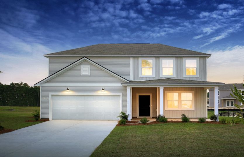 Rosella:Rosella New Home Exterior TD103 at Twilight with a covered front porch.