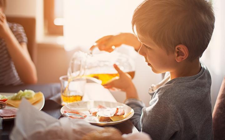 Boy in kitchen, at The Park at Harris Ridge in Austin, by Century Communities.