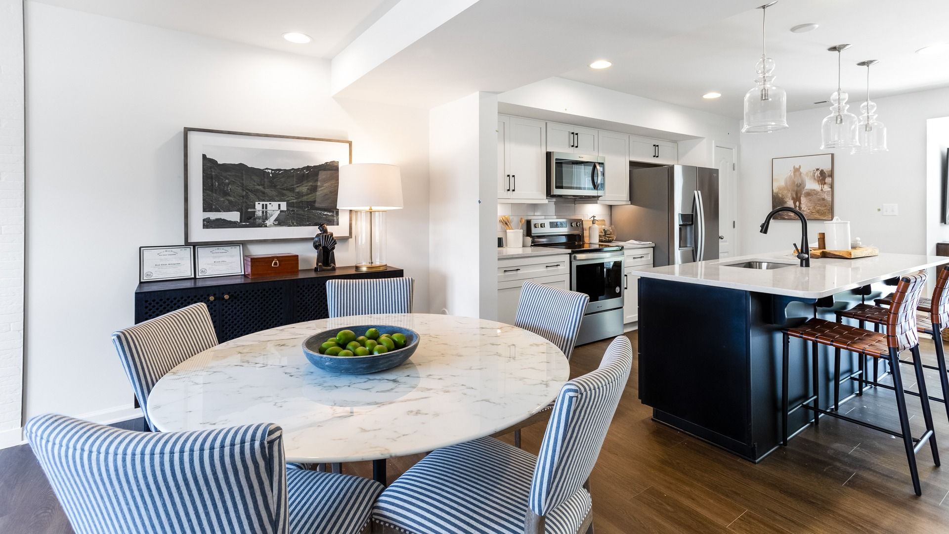Madison II Model at Whispering Pines - Breakfast Area and Kitchen:Open kitchen and adjoining breakfast area, wood floors, recessed and pendant lighting.