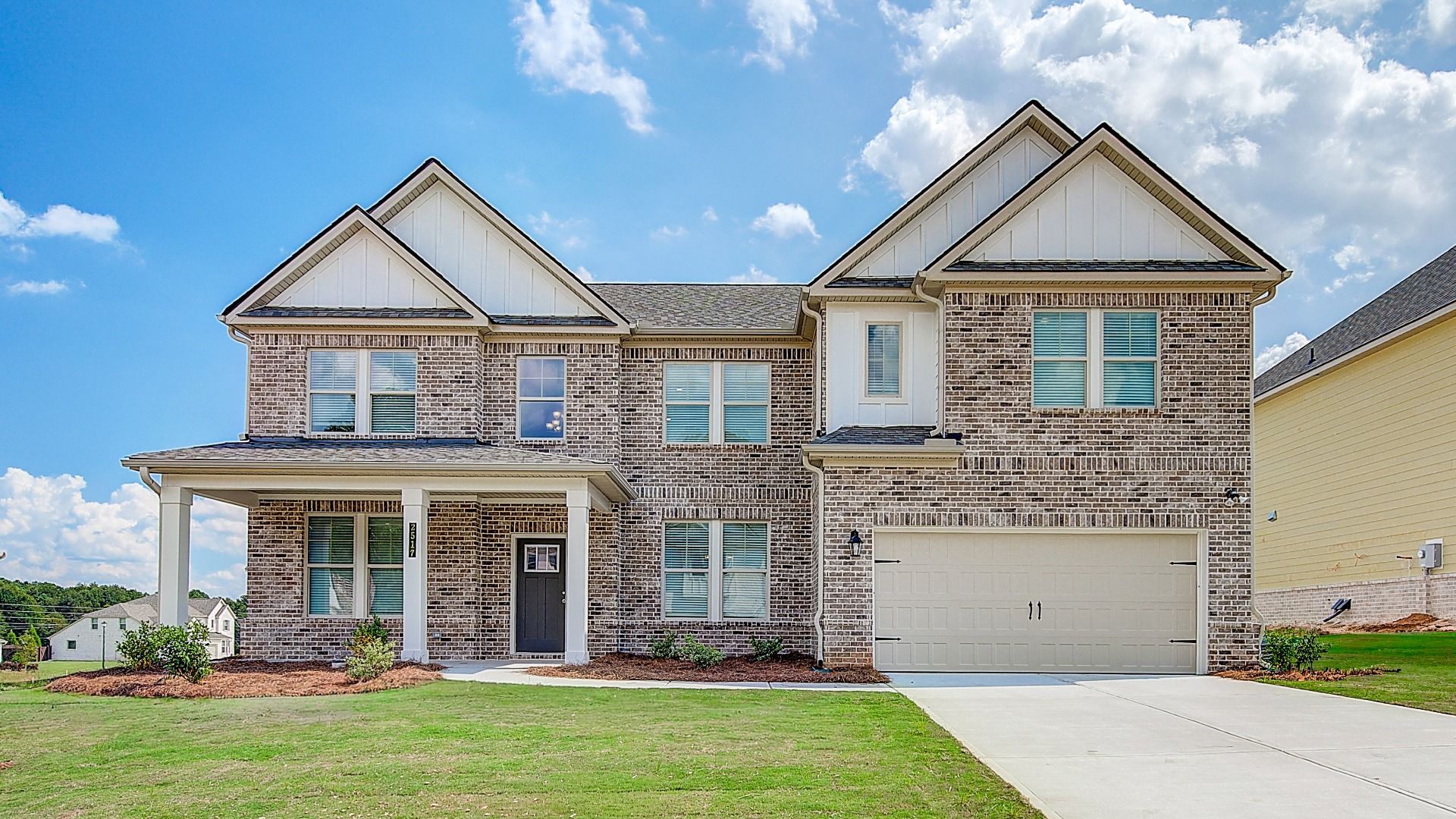 Elevation 6:Four-sided brick two-story Clarity home with covered entry and two-car front-entry garage at Adagio in Dacula, GA.