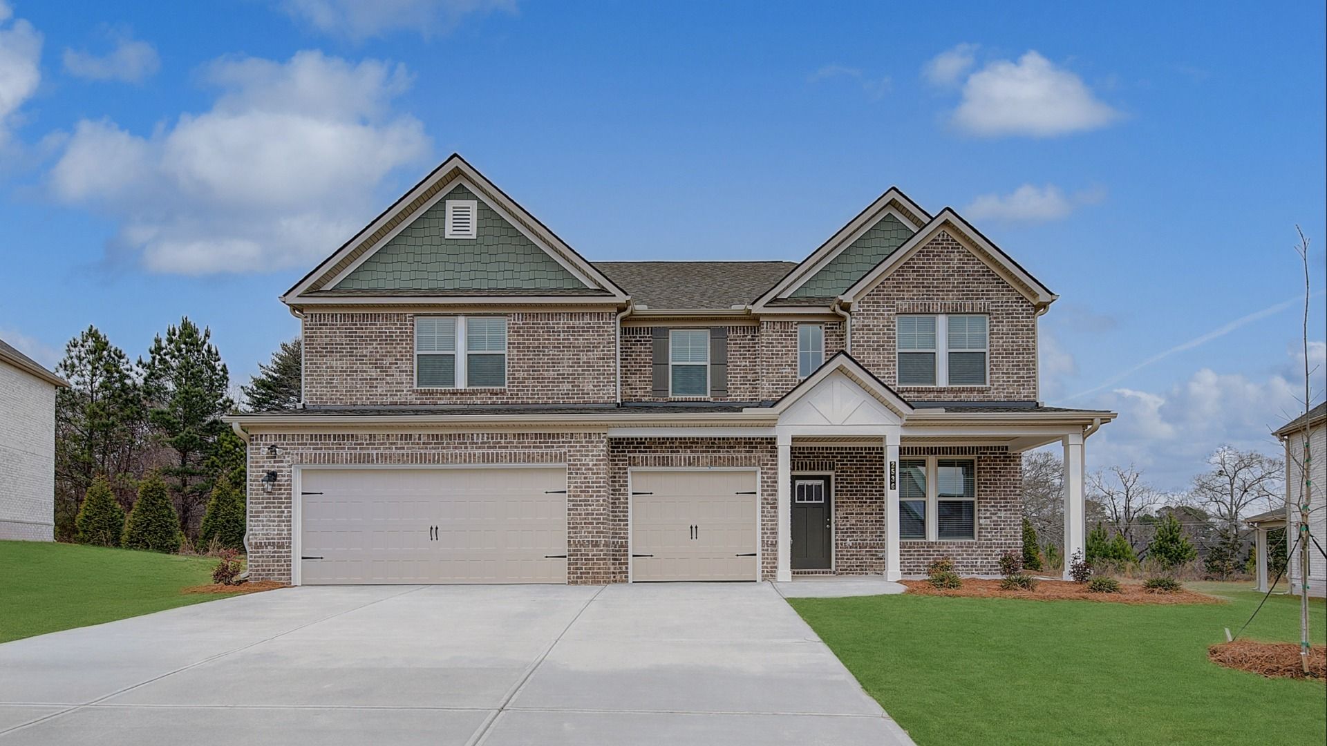 Elevation 5.4:Isabella II two-story home with three-car front-entry garage and classic four-sided brick exterior at Adagio in Dacula, GA.