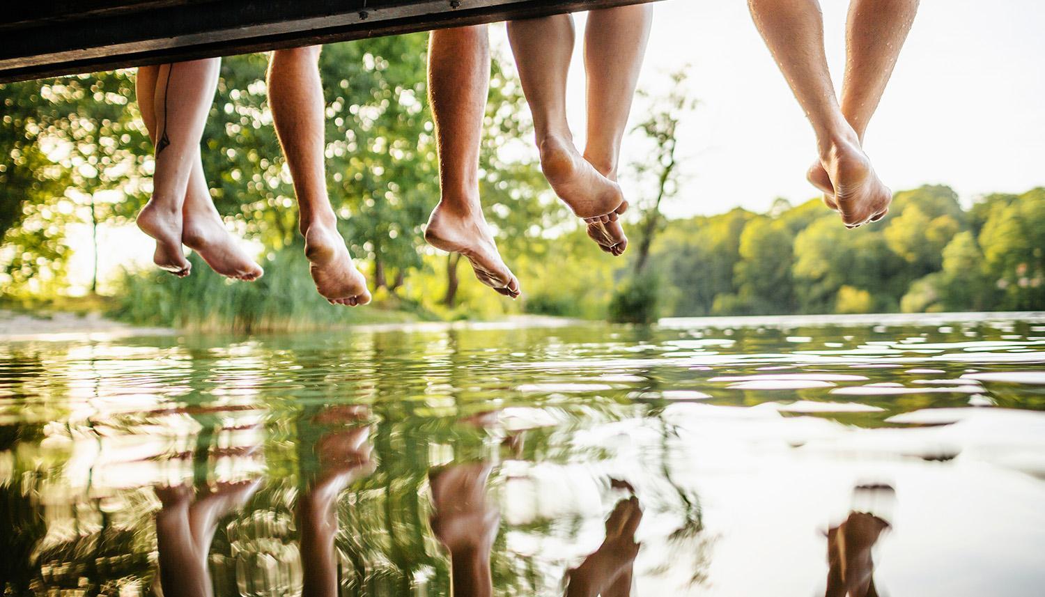 Vineyards Community, Image of children's legs and feet dangling over a river Mecklenburg County