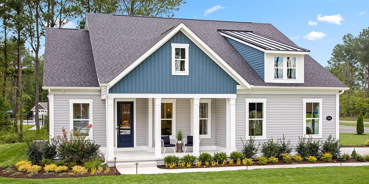 Beautiful single family home with front covered porch with light gray and blue exterior.