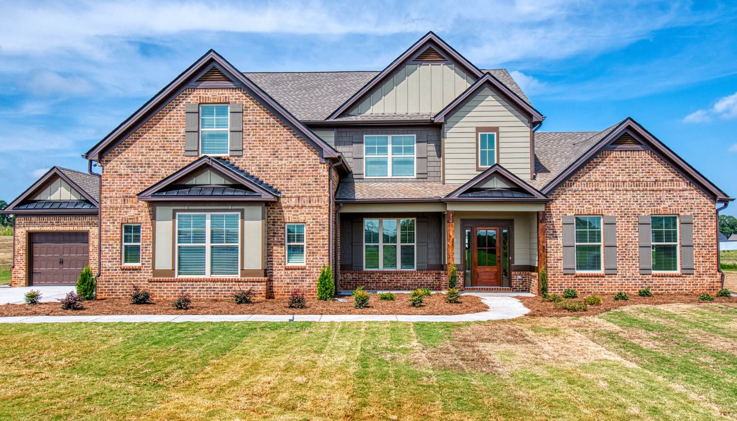 Single family home with brick front exterior and three car garage in  Graceton Farms