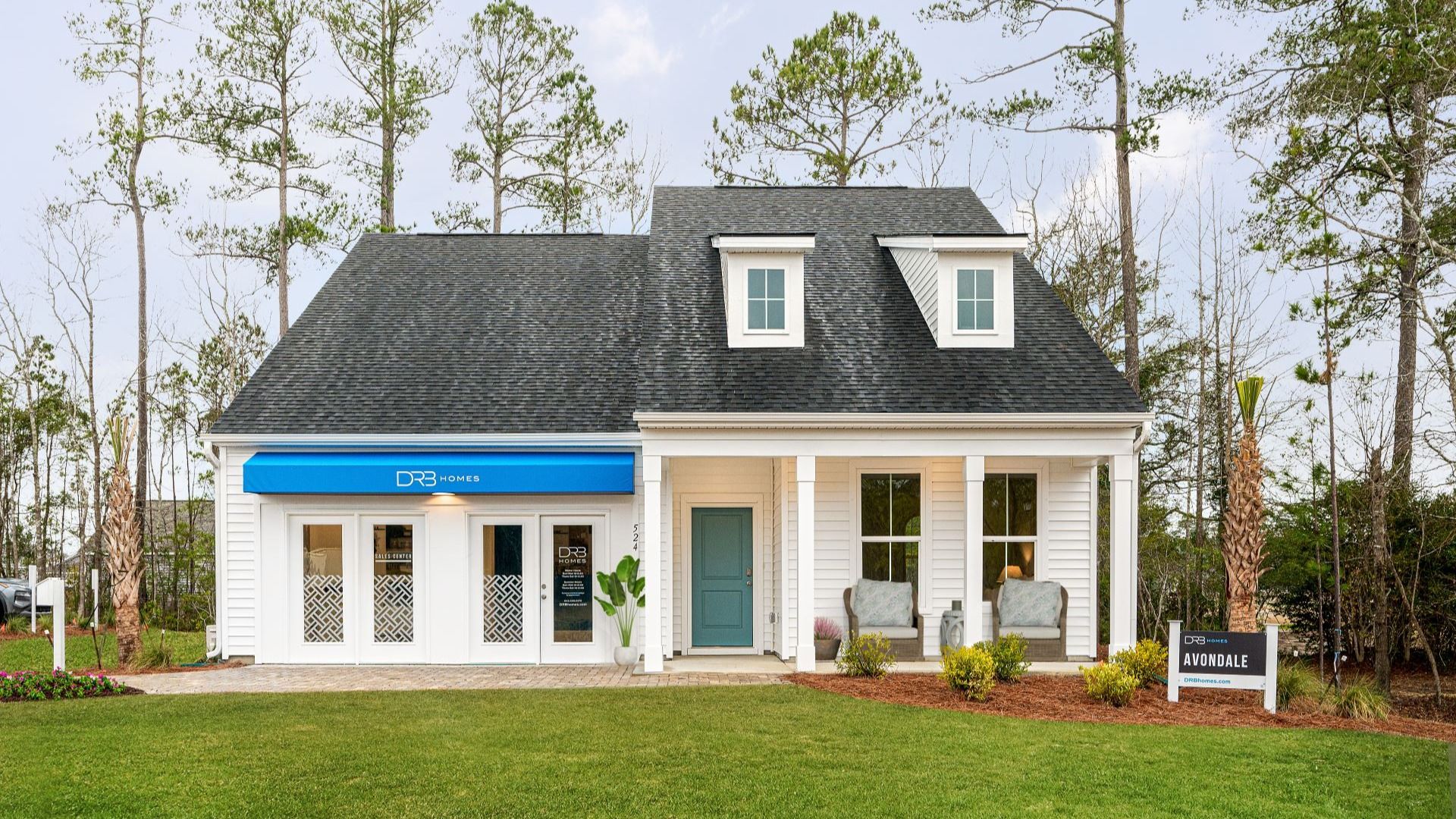 Avondale Model at Bluffs at Sun Colony:The Avondale model in Bluffs at Sun Colony by DRB homes offering a full front porch with its exterior being white wood
