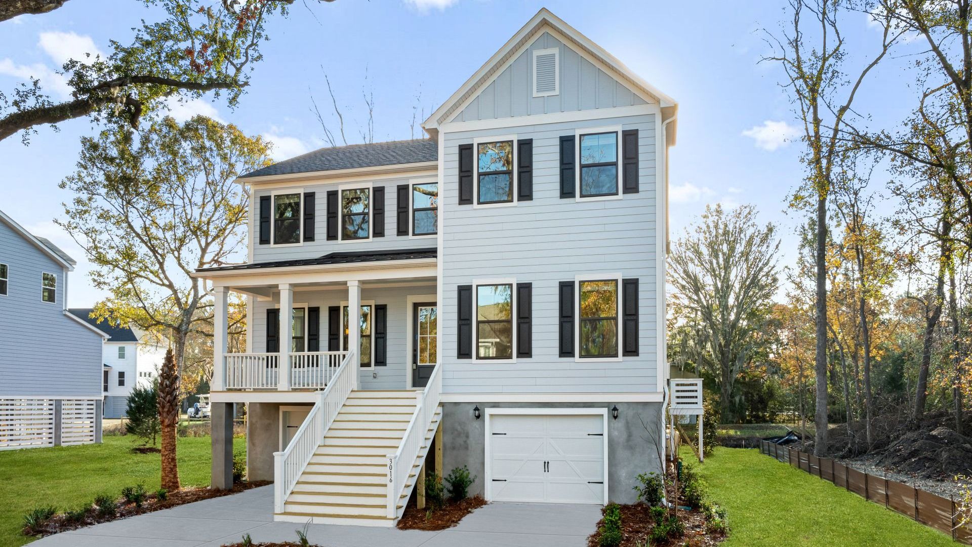 DJI_0363_1:Front of Briley Pointe by at DRB Homes features stairs to the upstairs and is painted white with black trimming
