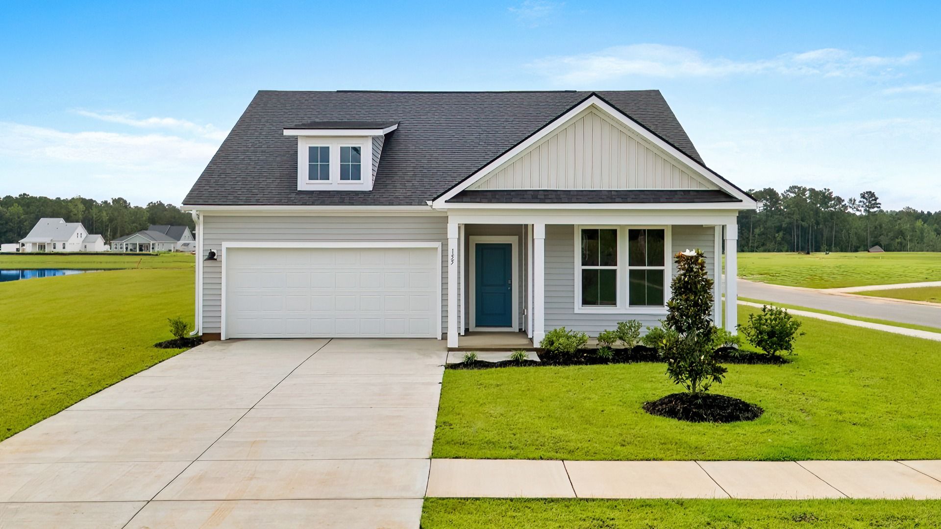 Exterior- 155 Joyce Drive:Craftsman-style exterior of 155 Joyce Drive with covered porch at Chestnut Farms by DRB Homes
