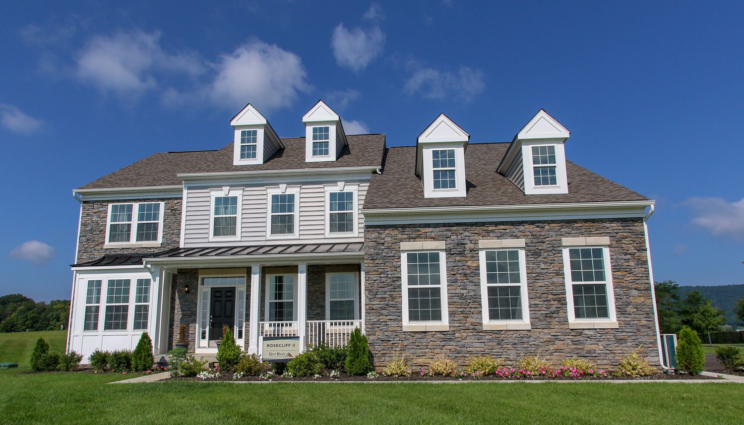 Stately single family home in Martinsburg, WV with partial stone front and covered front porch.