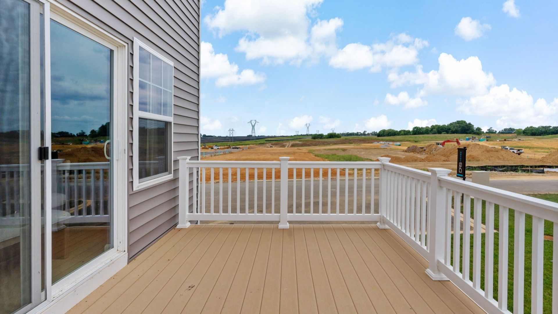 York II Balcony:Spacious balcony in York II South Brook Townhome by DRB Homes with scenic views and comfortable seating in Inwood, WV.
