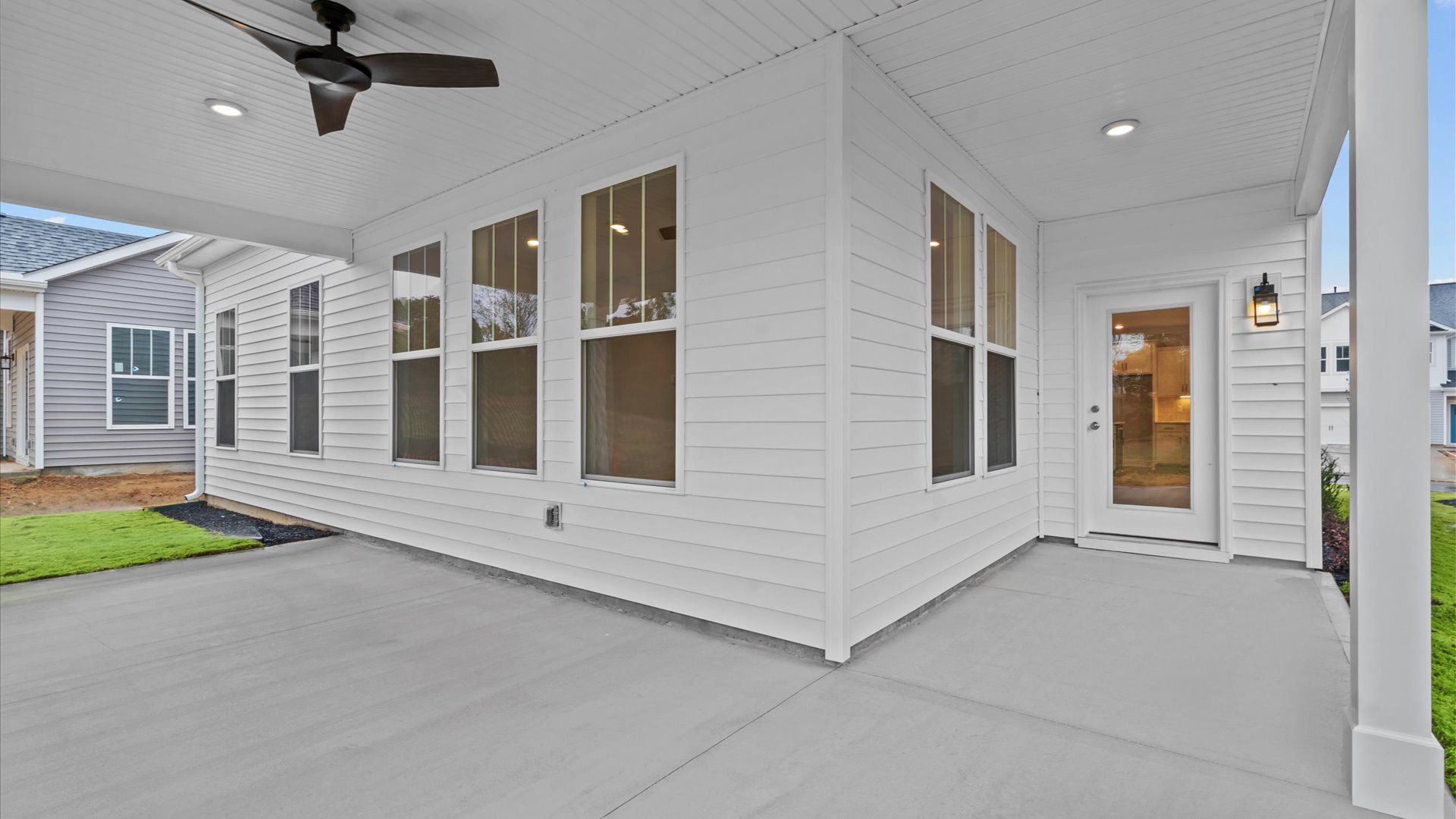 Exclusive rear covered porch with accomplished detail and elevated outdoor living potential:Refined rear exterior with a stylish covered porch for dining, relaxing, or entertaining