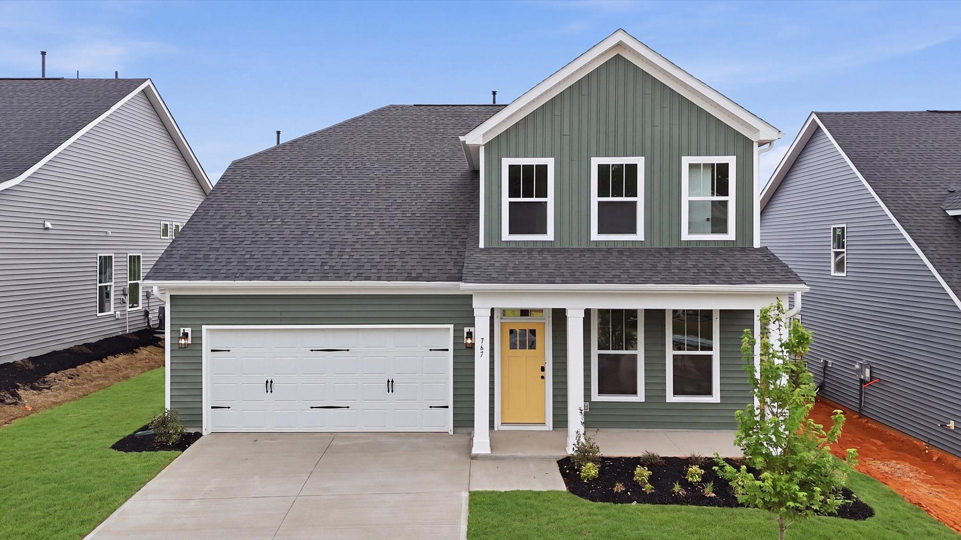 Inviting covered entry sets the tone for this beautifully crafted residence:Exceptional home with tasteful exterior finishes and a thoughtfully designed façade at the Iris Meadows community
