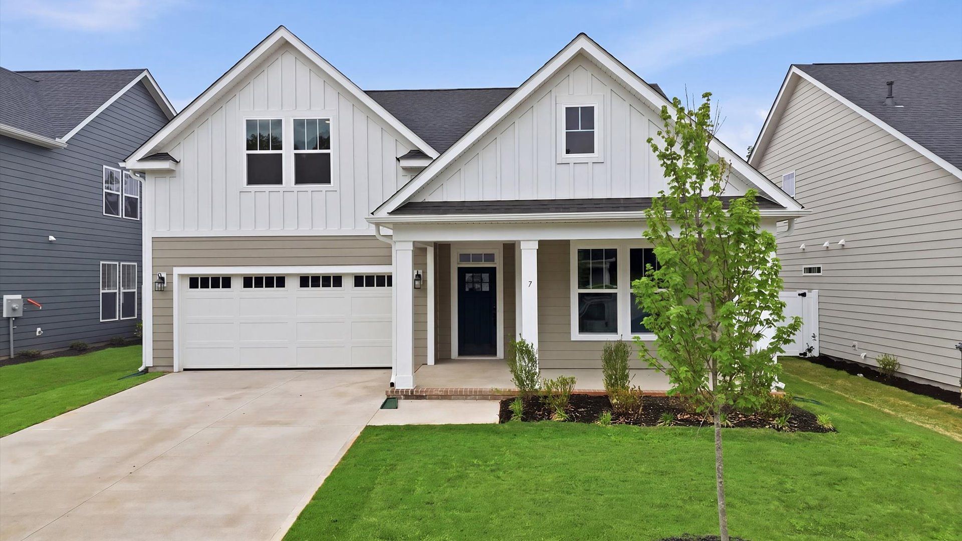 Inviting covered entry sets the tone for this beautifully crafted residence:Exclusive DRB Homes exterior with balanced proportions and vibrant curb appeal located in Greenville, SC