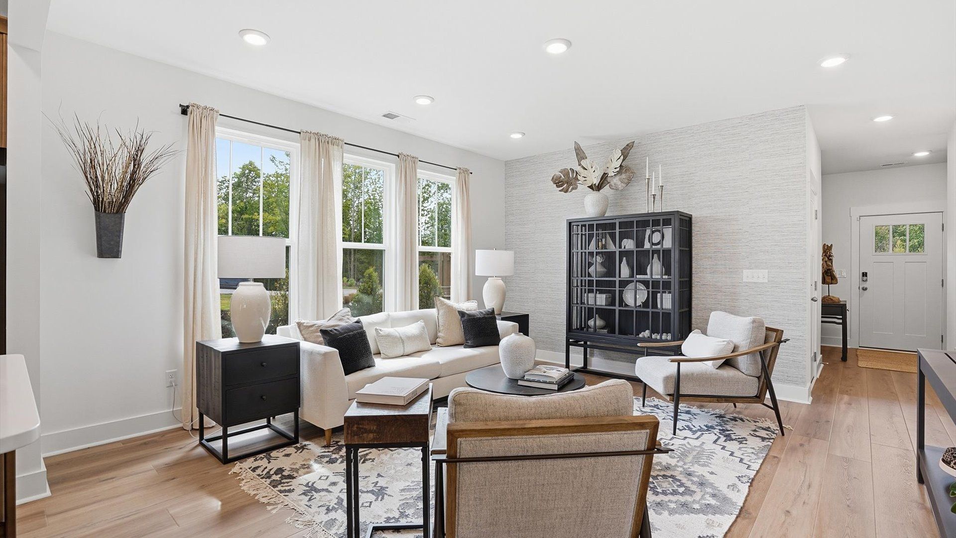 Exceptional family space with hardwood floors and seamless flow to dining and kitchen areas:Spacious family room with rich hardwood flooring and elegant trim work in a reputable DRB Homes build at Gresham Station