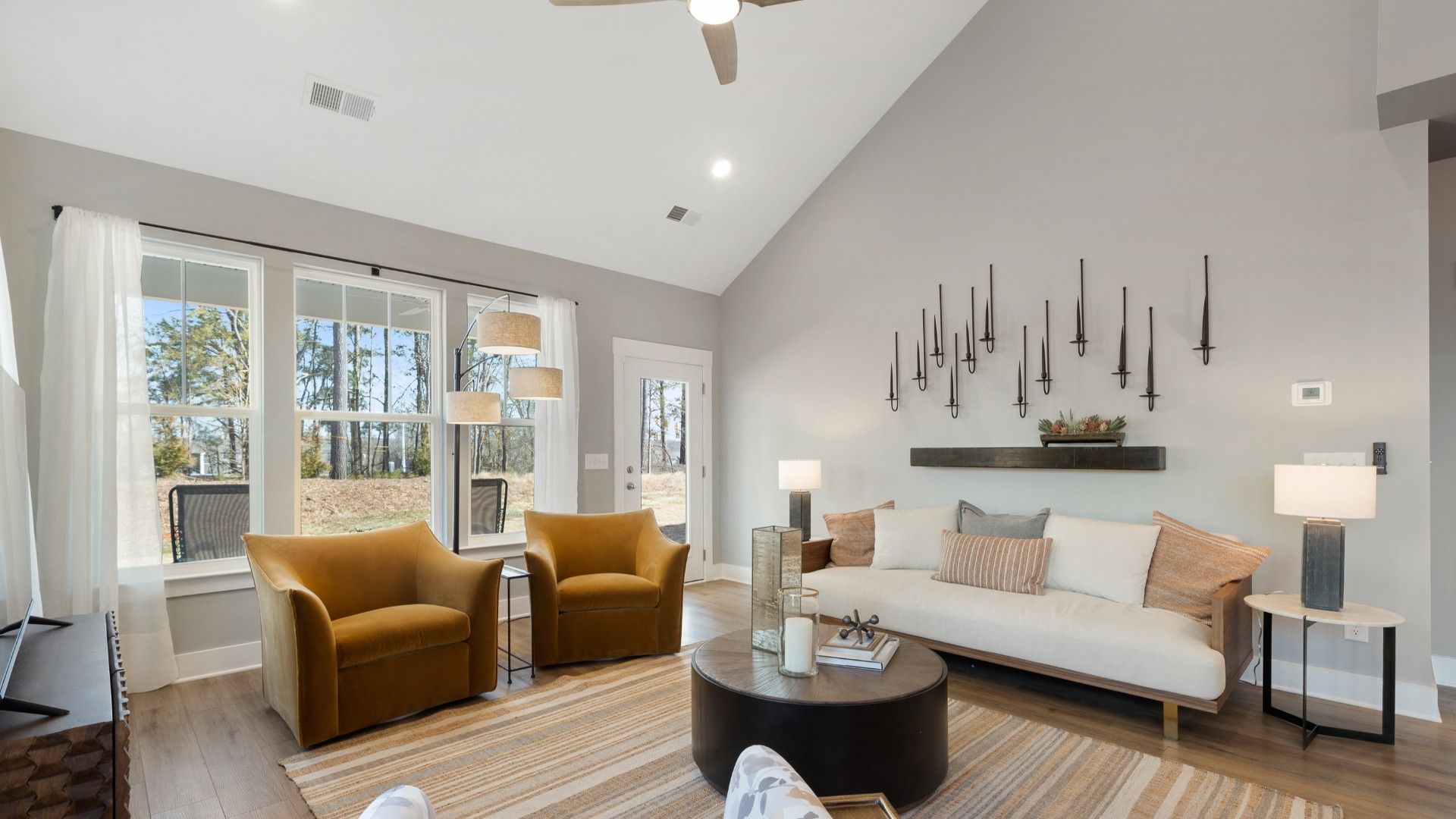 Lakehurst plan with modern decor, gray walls, and large windows at Village at Midway:Family room with modern decor, gray walls, large windows and two story ceiling at Village at Midway by DRB Homes in Anderson