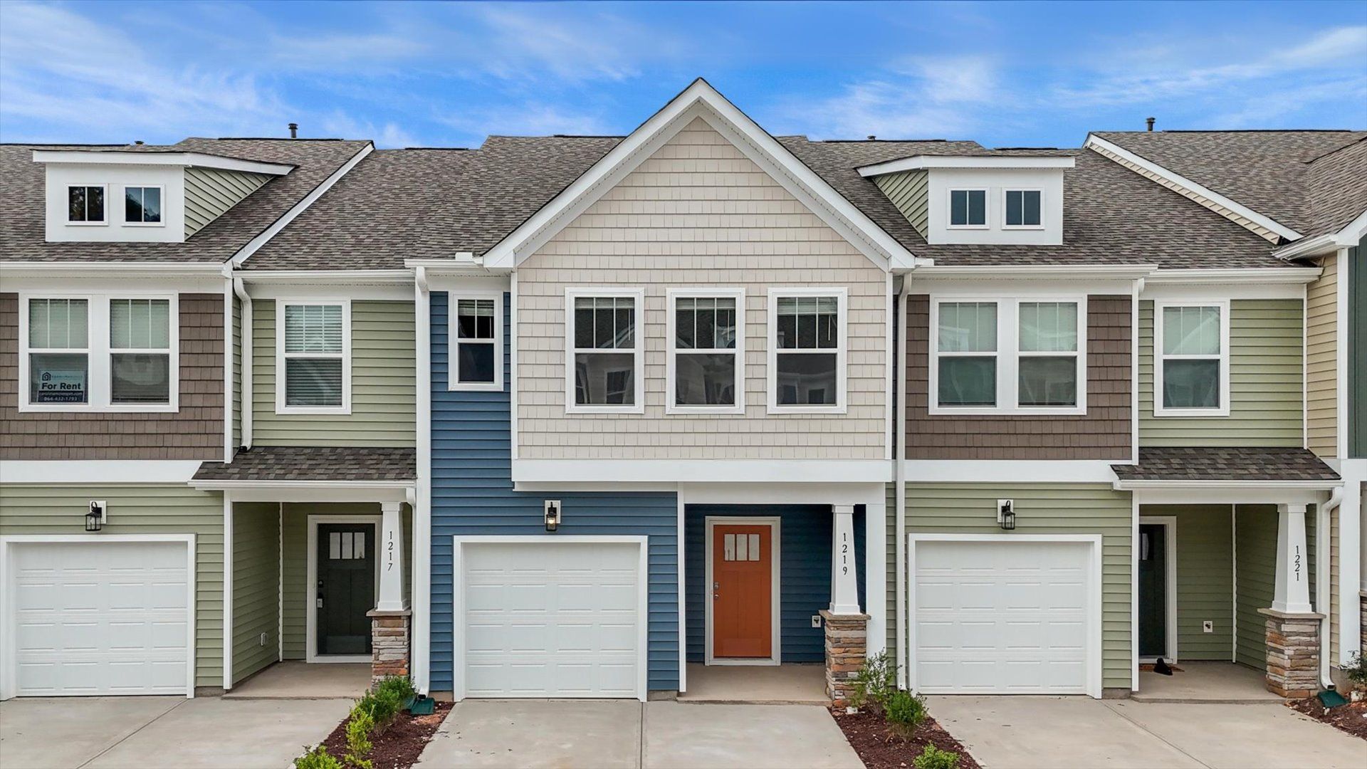 Blue and cream exterior two story townhome near at Tyger Ridge by DRB Homes in Spartanburg, SC:New two story townhomes at Tyger Ridge in Spartanburg, SC near BMW Manufacturing