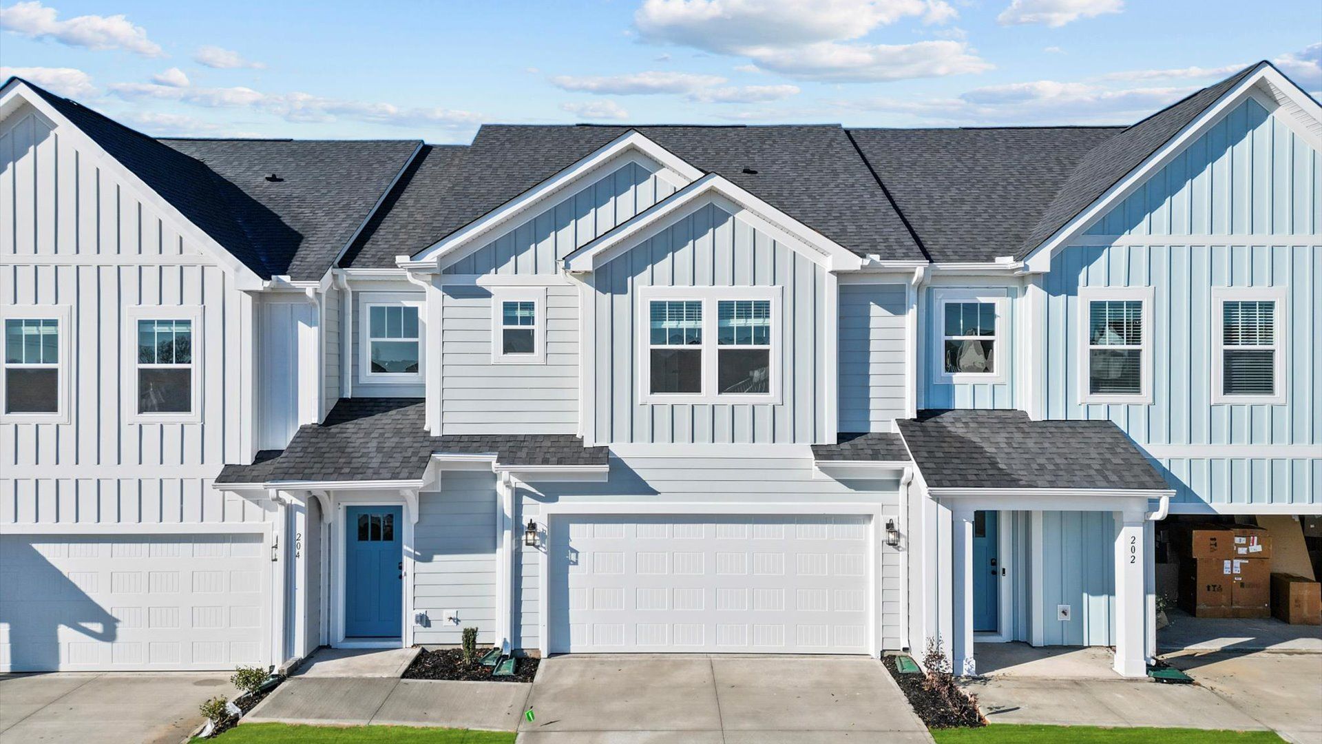 Exterior of two story townhome at Village at Midway by DRB Homes in Anderson, SC:Stunning white exterior two story townhome with two car garage at Village at Midway by DRB Homes in Anderson, SC