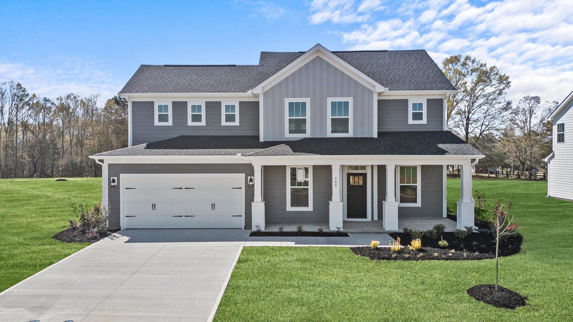 Spacious home in Woodruff, SC at Pinebrook by DRB Homes with plentiful windows and a covered porch