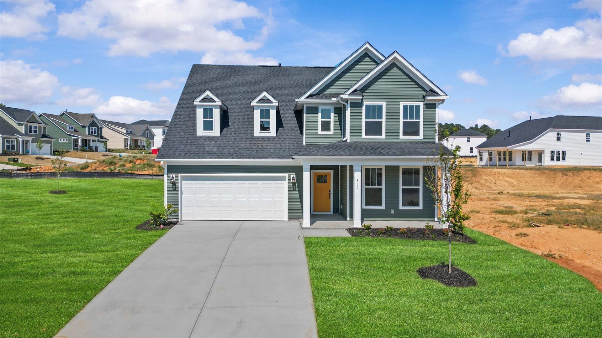 Exterior of two story home in Iris Meadows by DRB Homes in Moore, SC:Gorgeous two story home with dark green siding and front porch