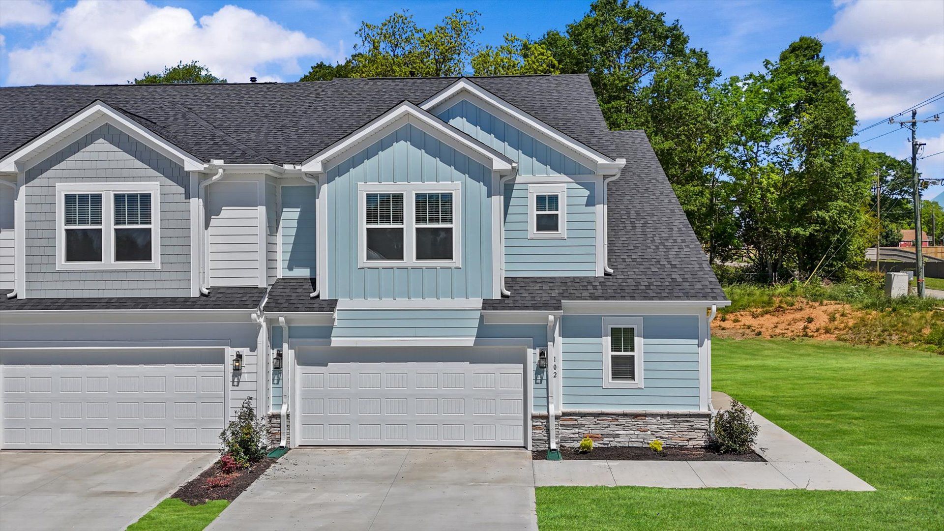 Exterior of two story townhome at Village at Midway by DRB Homes in Anderson, SC:Exterior of townhome with two car garage at Village at Midway by DRB Homes in Anderson, SC