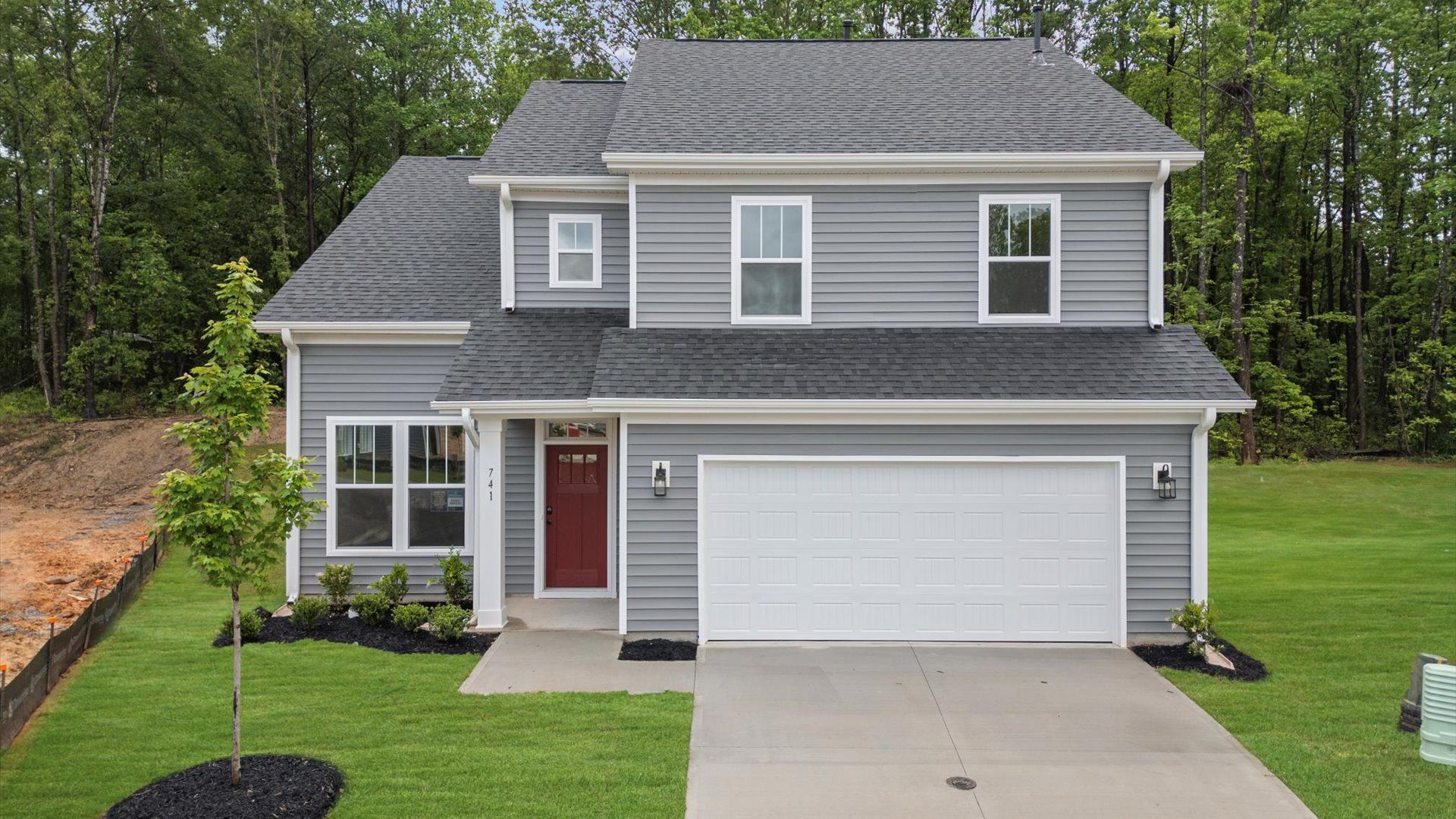 Exterior of two story home at Magnolia Park by DRB Homes in Woodruff, SC:Gray exterior home with two car garage at Magnolia Park by DRB Homes in Woodruff, SC
