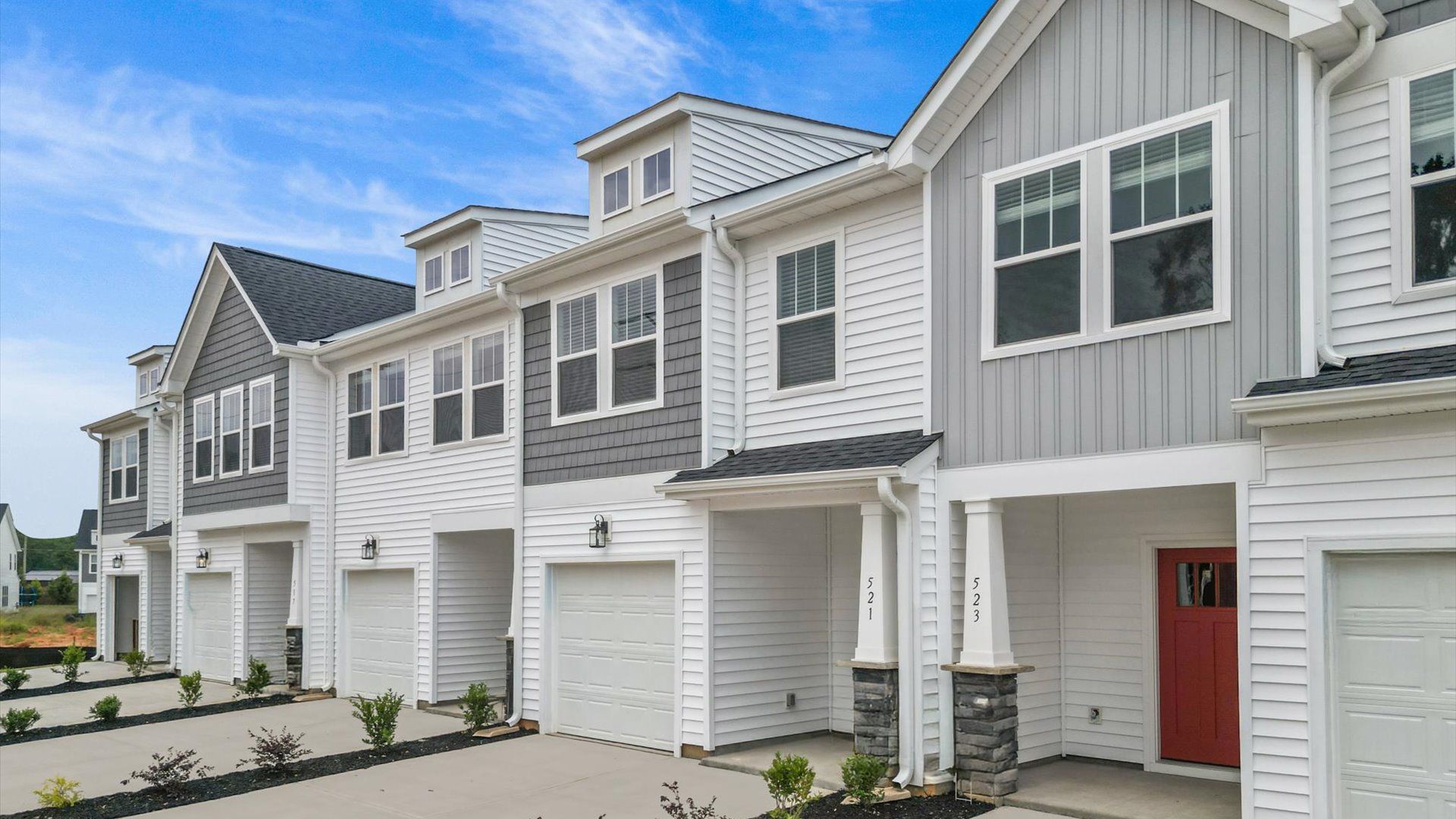 Brand new white exterior two story townhome at Hickory Heights by DRB Homes:New two story townhomes with two car parking pad & one car garage at Hickory Heights by DRB Homes in Downtown Greenville, SC