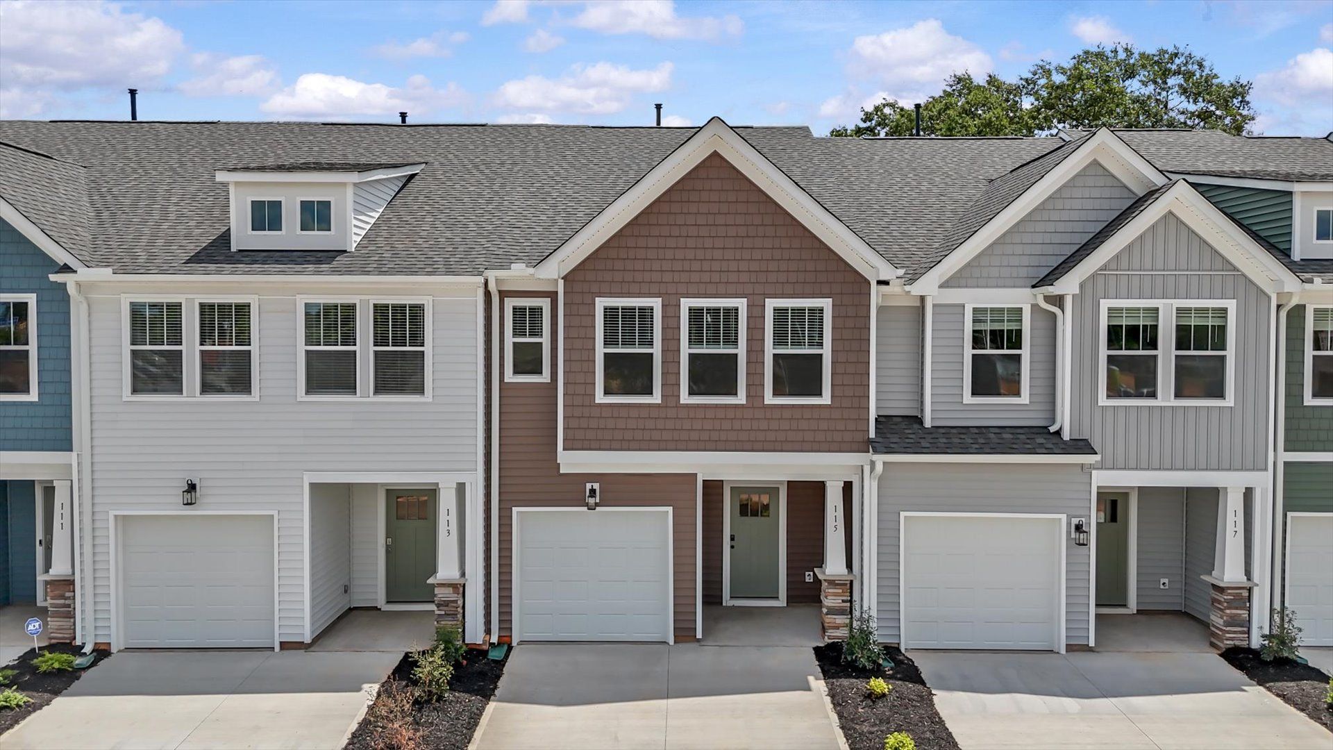 Exterior of two story townhome at Saluda Crossing by DRB Homes in Piedmont, SC:Superior craftsmanship throughout this established townhome community in Piedmont, SC at Saluda Crossing by DRB Homes