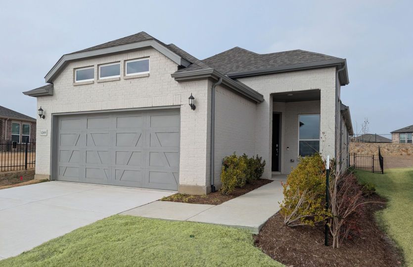 Exterior:New Construction - The Contour, a one-story home with 2-car garage