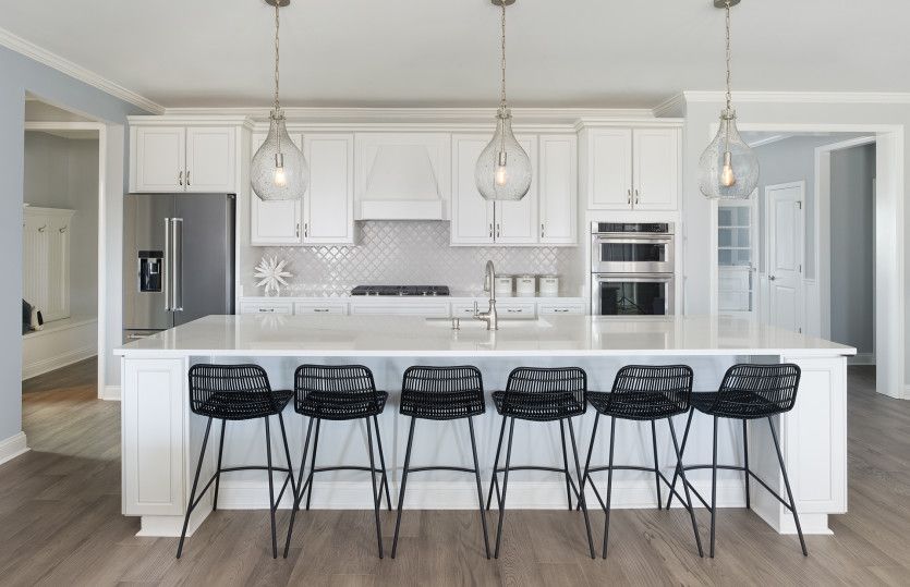 Stardom:Open Kitchen with a tray ceiling and a large island providing space for extra seating.