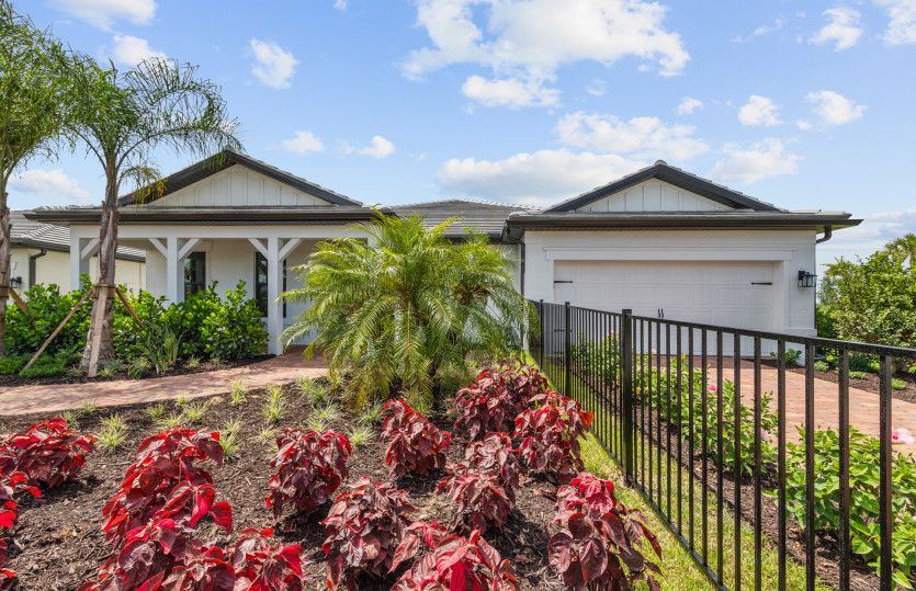Renown:Beautiful exterior of new construction home in Del Webb Naples, FL