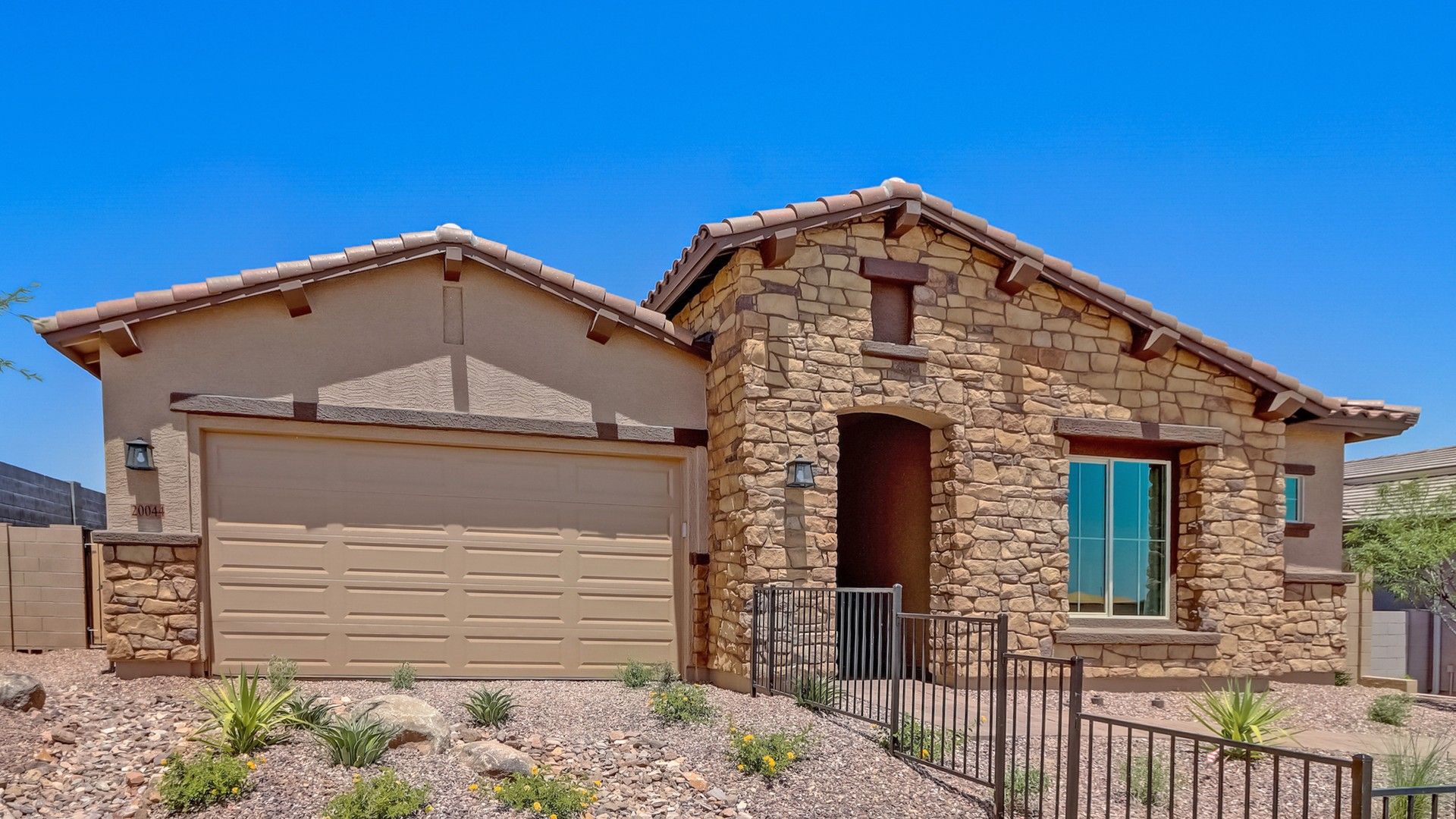Canyon Views Hacienda Topaz home with stone facade at 20044 W El Nido Ln.:Elegant stone facade and tile roof enhance this Canyon Views home at 20044 W El Nido Ln.