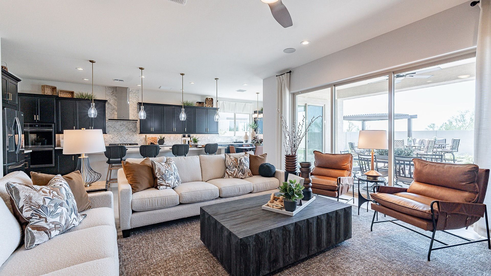 Spacious Living Room in Windrose Community:Experience luxury with plush seating, sleek cabinetry, and seamless indoor-outdoor flow in Windrose.