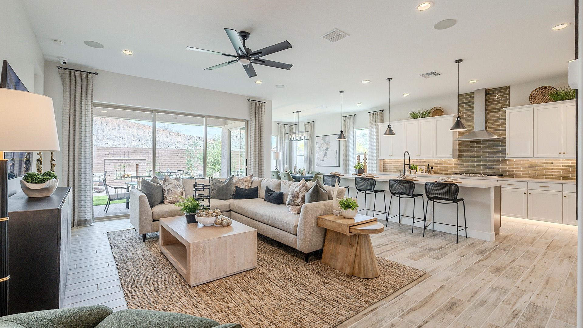 Open-Plan Living Room and Kitchen in Hacienda at Estrella:Luxurious open-plan design with elegant finishes, oversized windows, and natural light in Hacienda at Estrella.