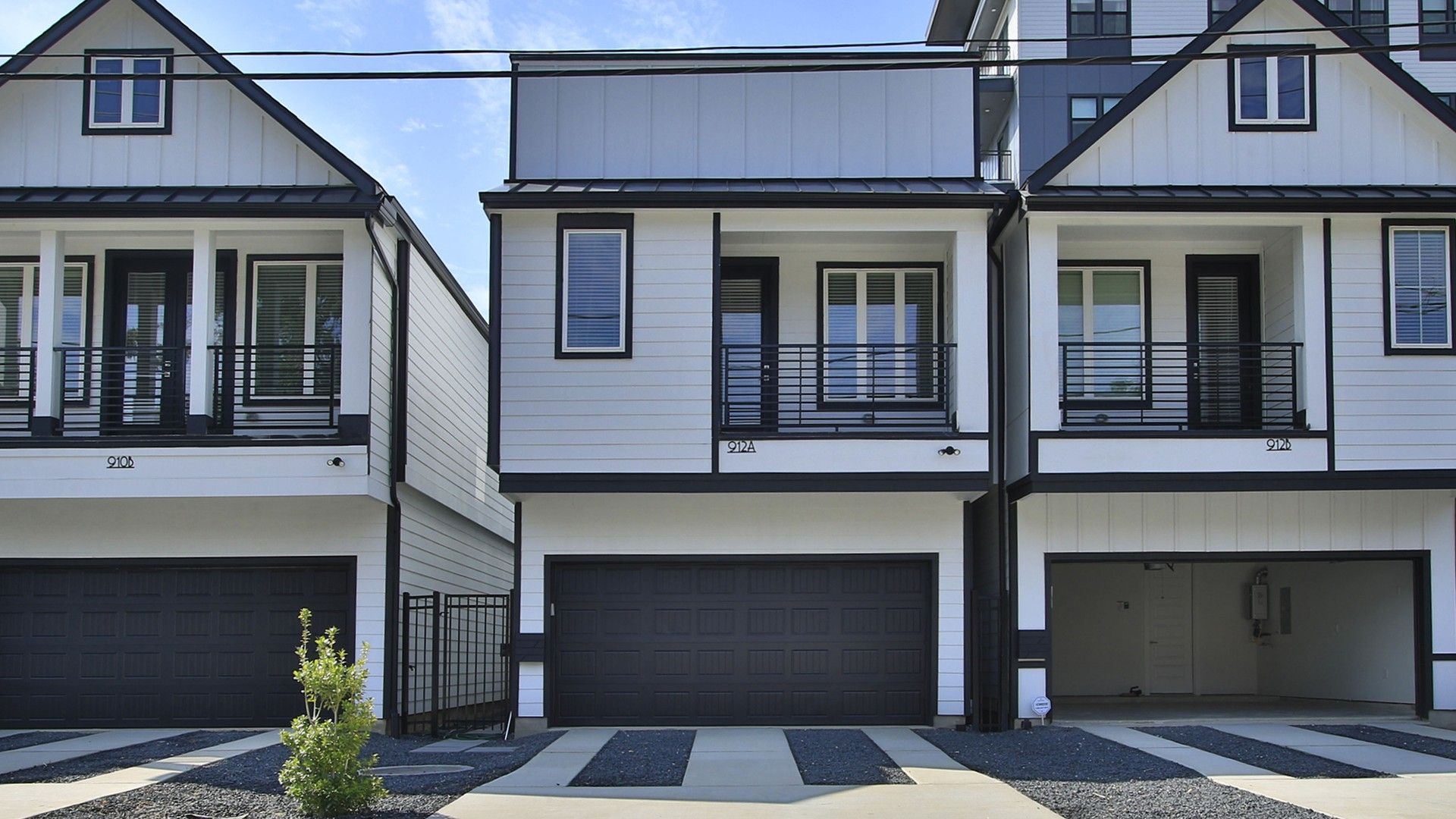 Two-story Home with Balcony and Garage in Shady Acres:Elegant Shady Acres home features a gray facade, expansive balcony, and sleek modern architecture.