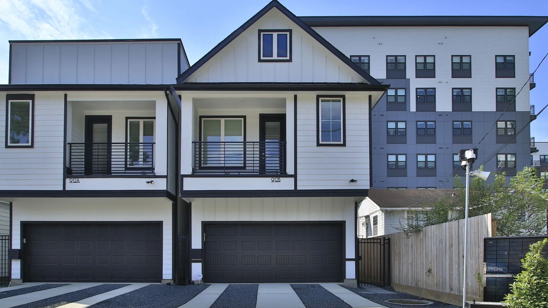 Shady Acres Detached Townhome Exterior at 912B W 21st Street, Houston:Sleek detached townhome facade with dual garages and modern design in Shady Acres, Houston.