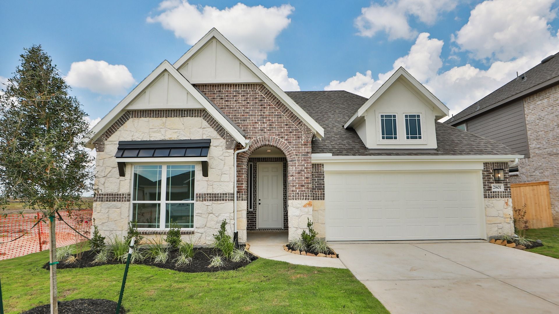 Stone Facade Home with Gabled Roof at Oleander Creekhaven:Elegant stone exterior and prominent gabled roof create a luxurious facade, Oleander at Creekhaven.