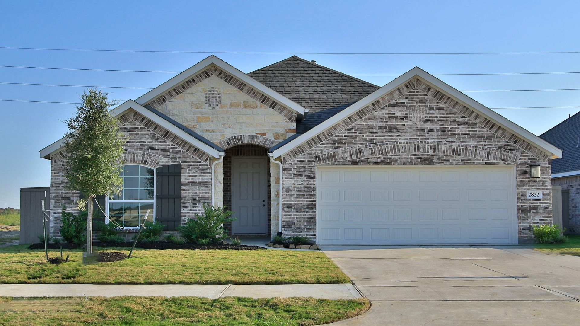 Elegant Brick House with Arched Doorway in Creekhaven:Experience luxury with arched entrances and classic brickwork in the exclusive Creekhaven community.