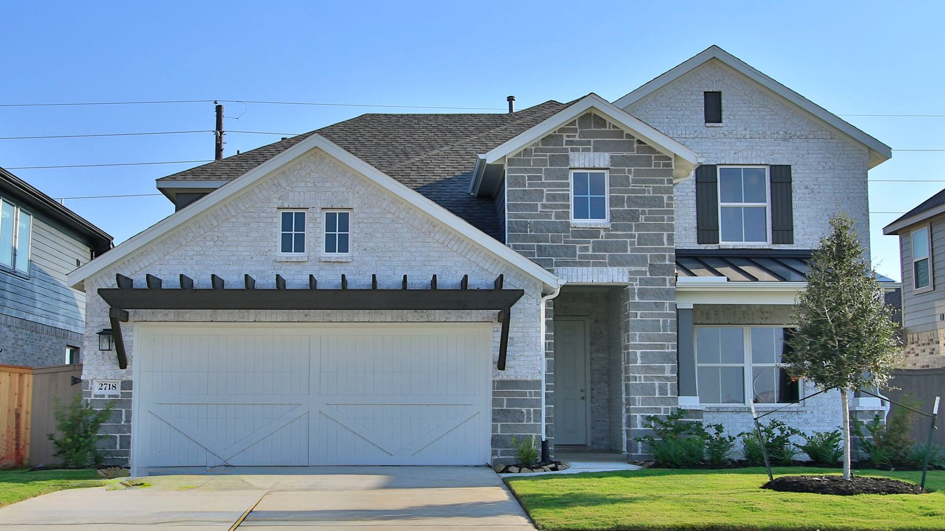 Two-Story Stone House in Creekhaven with Gable Roof and Landscaping:Luxurious stone facade, gable roof, elegant wooden shutters in Creekhaven community.