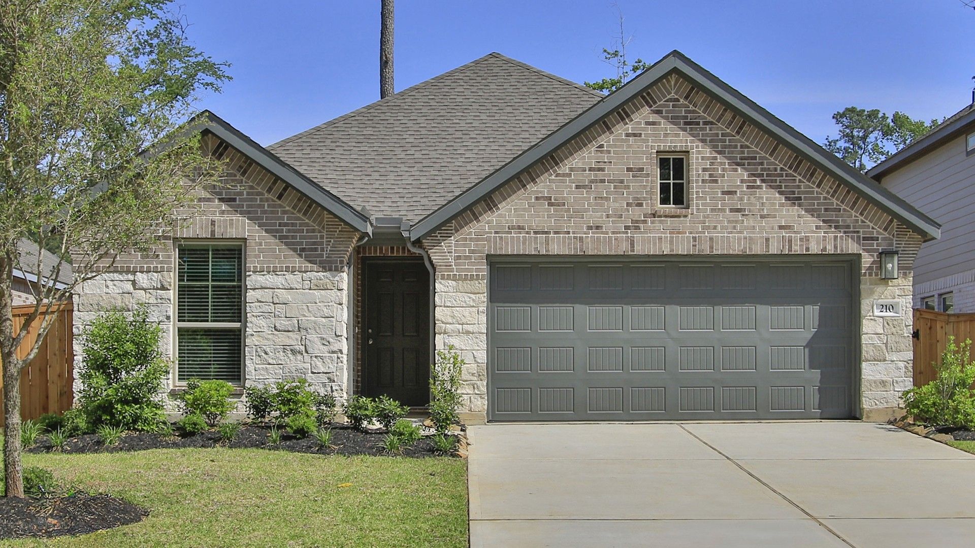 Modern Brick and Stone House in The Woodlands Hills, Texas:Elegant gable roof and stone facade define this residence in The Woodlands Hills, exuding refined appeal.
