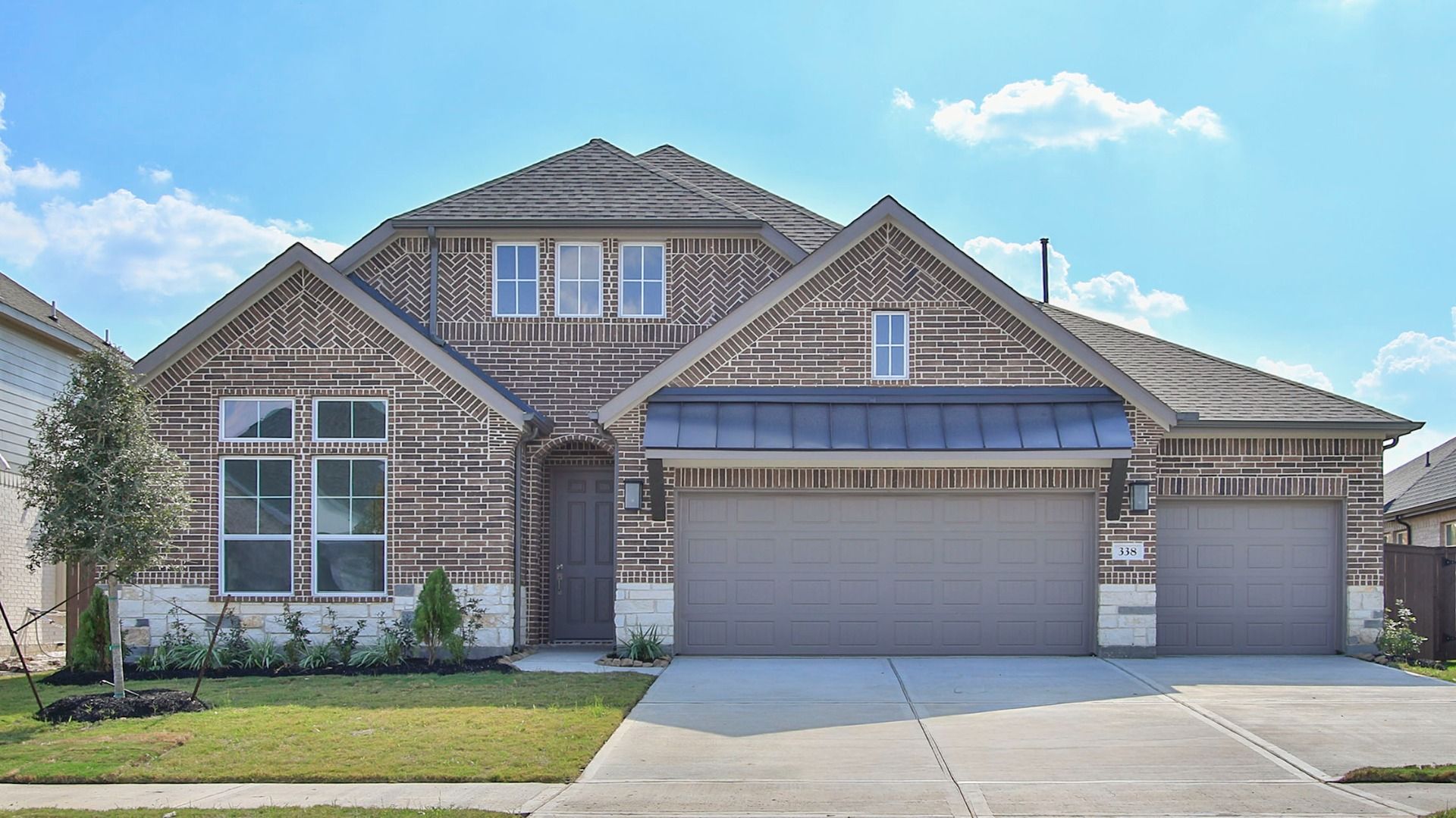 Vanderbilt Brookewater Modern White Brick Home with Gabled Roof and Garage:Exquisite white brick facade and expansive three-car garage define luxury living in Brookewater's Vanderbilt.