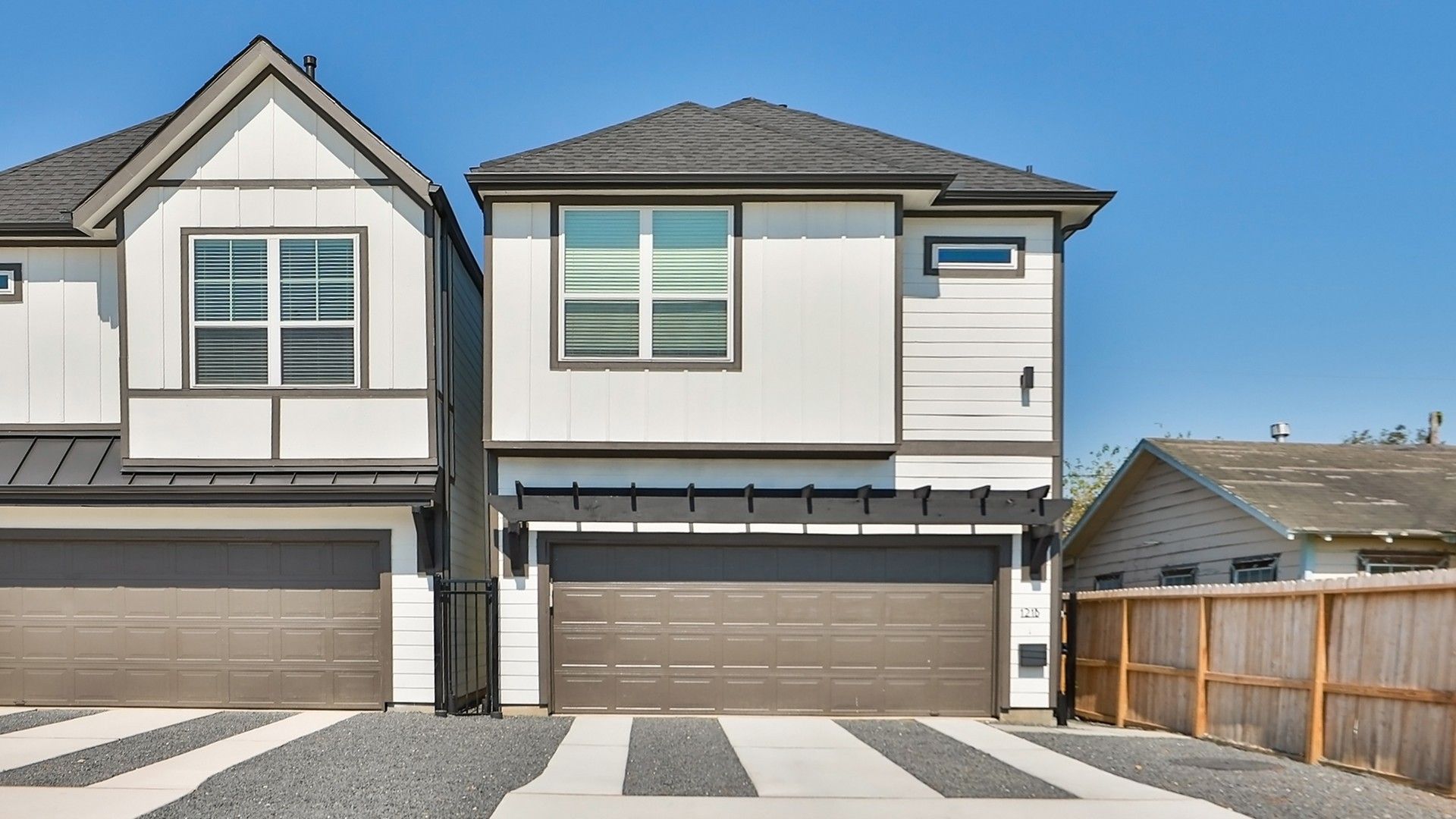 Modern Townhouses in Independence Heights with Gabled Roofs and Garages:Sleek townhouses in Independence Heights feature minimalist design, gabled roofs, and elegant garage structures.