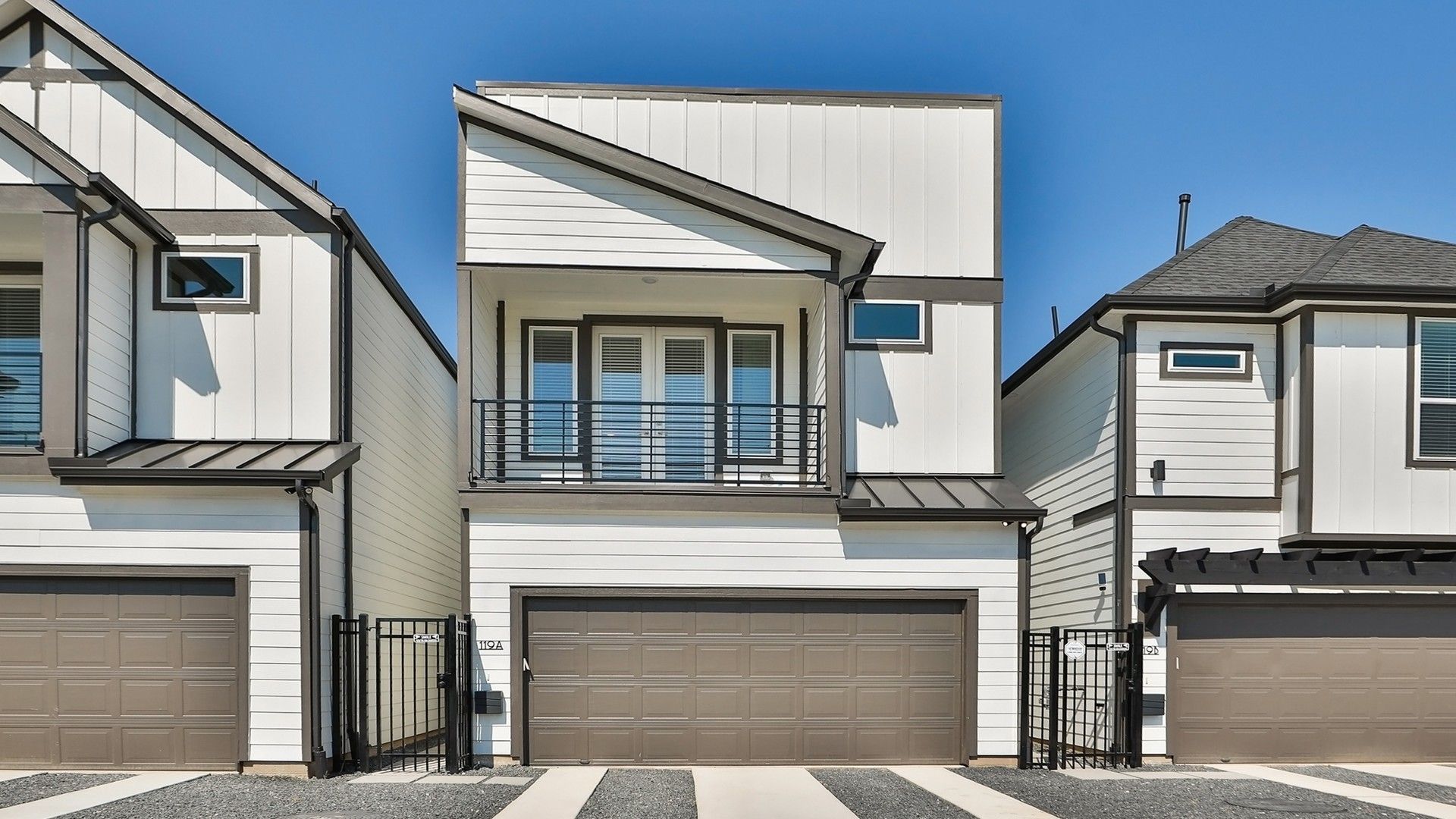 Modern Townhouse with Balcony and Garage in Independence Heights:Sleek metal accents and spacious design elevate this Independence Heights townhouse to modern luxury.
