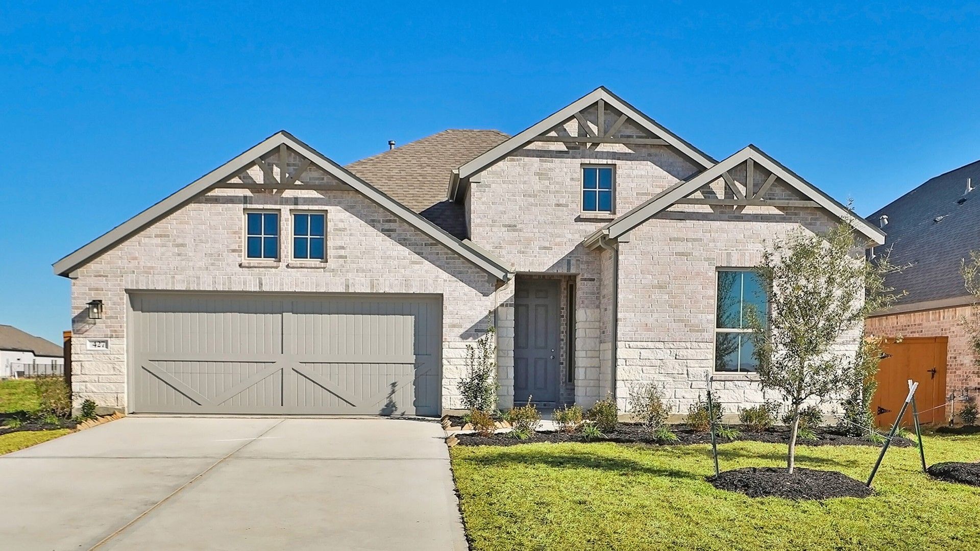 Modern Brick Home with Gabled Roof in River Ranch:Experience elegance in this River Ranch home with refined brickwork, gabled roof, and pristine landscaping.