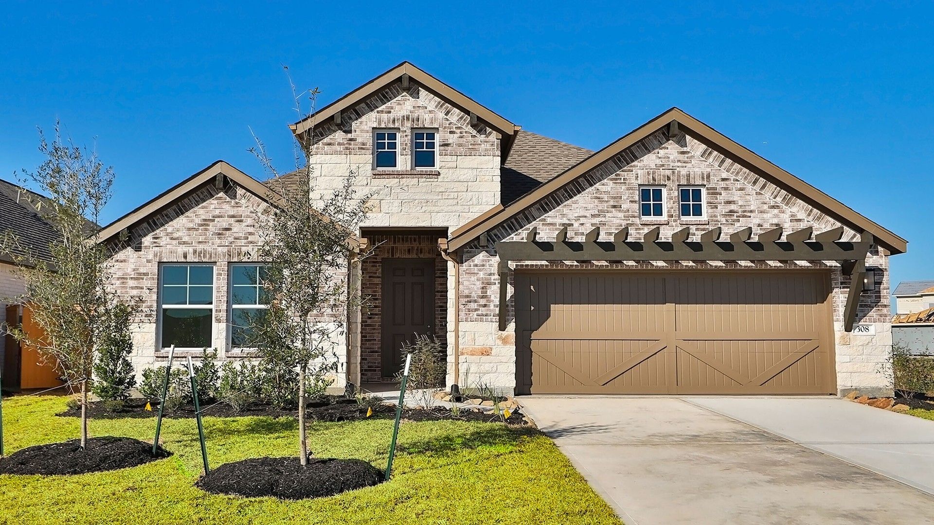 Modern Ranch Home with Pergola, River Ranch:Elegant brick and stone facade with a wooden pergola adds timeless appeal. Located in prestigious River Ranch.