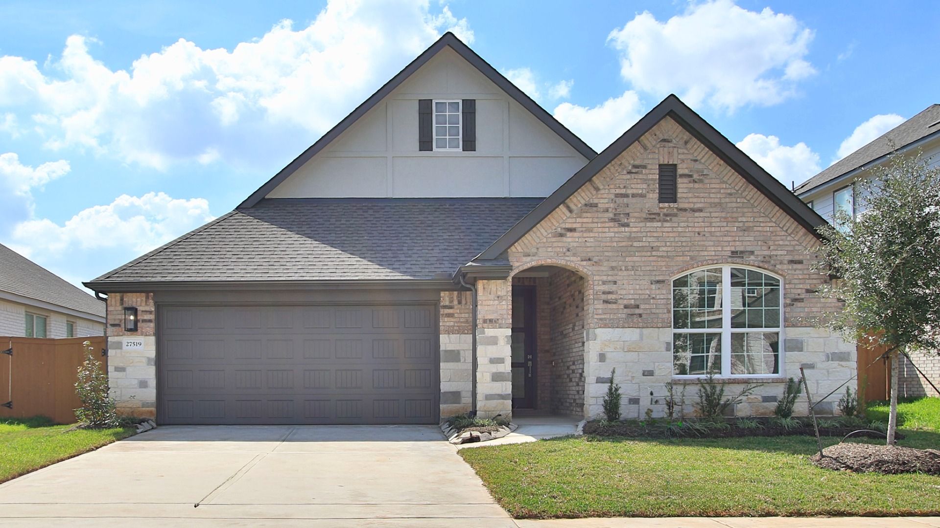 Mahogany Brick and Stone Home at Sunterra Community, Tudor Style:Exquisite brickwork and stone facade elevate this Tudor-style masterpiece in Sunterra's luxurious setting.
