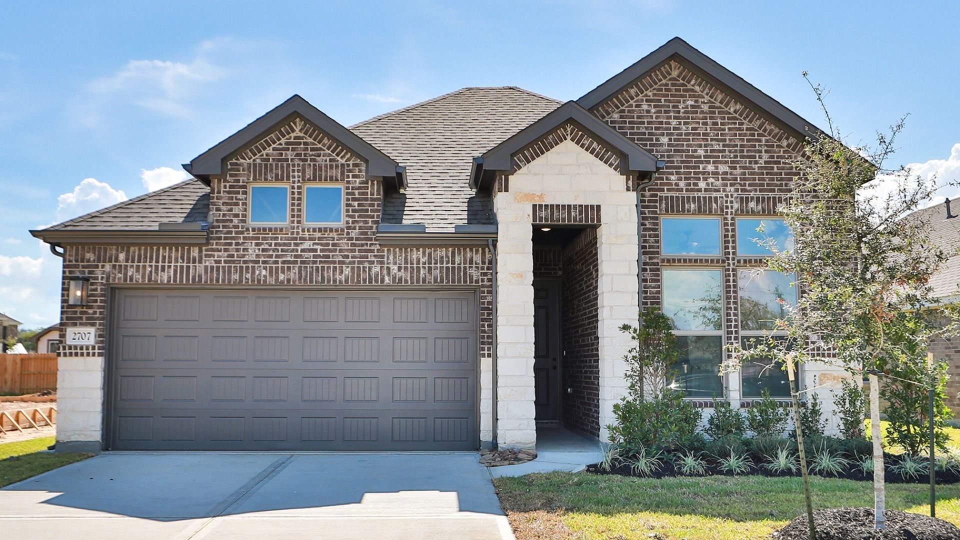 Brick and Stone Home Exterior at Aruba, Ellis Cove:Experience refined craftsmanship with brick and stone facade in Aruba at Ellis Cove. Chic design meets comfort.