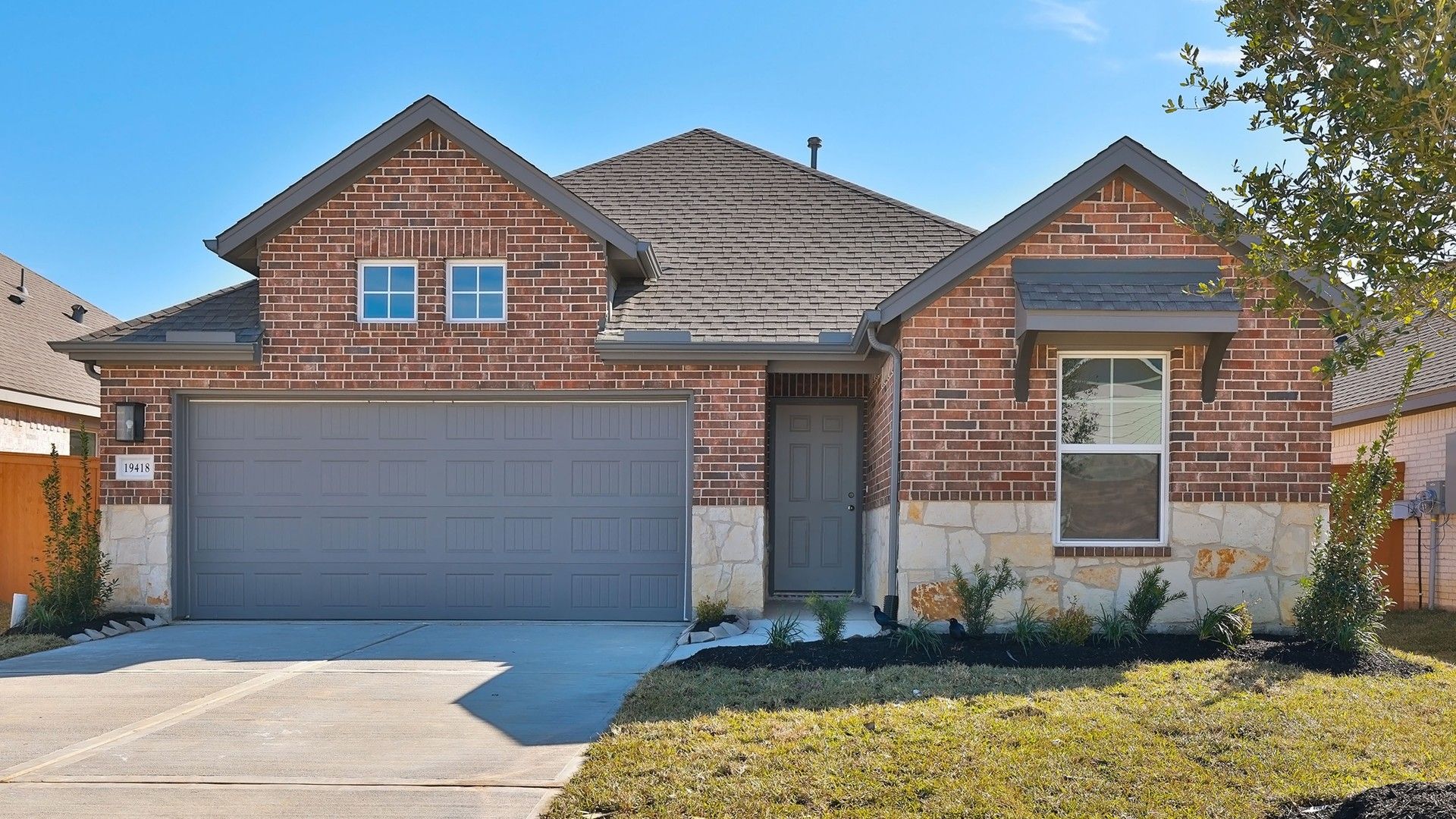 Red Brick House in Cypress Green with Modern Architecture:Elegant red brick facade with stylish stone accents exemplifies luxury at Cypress Green.