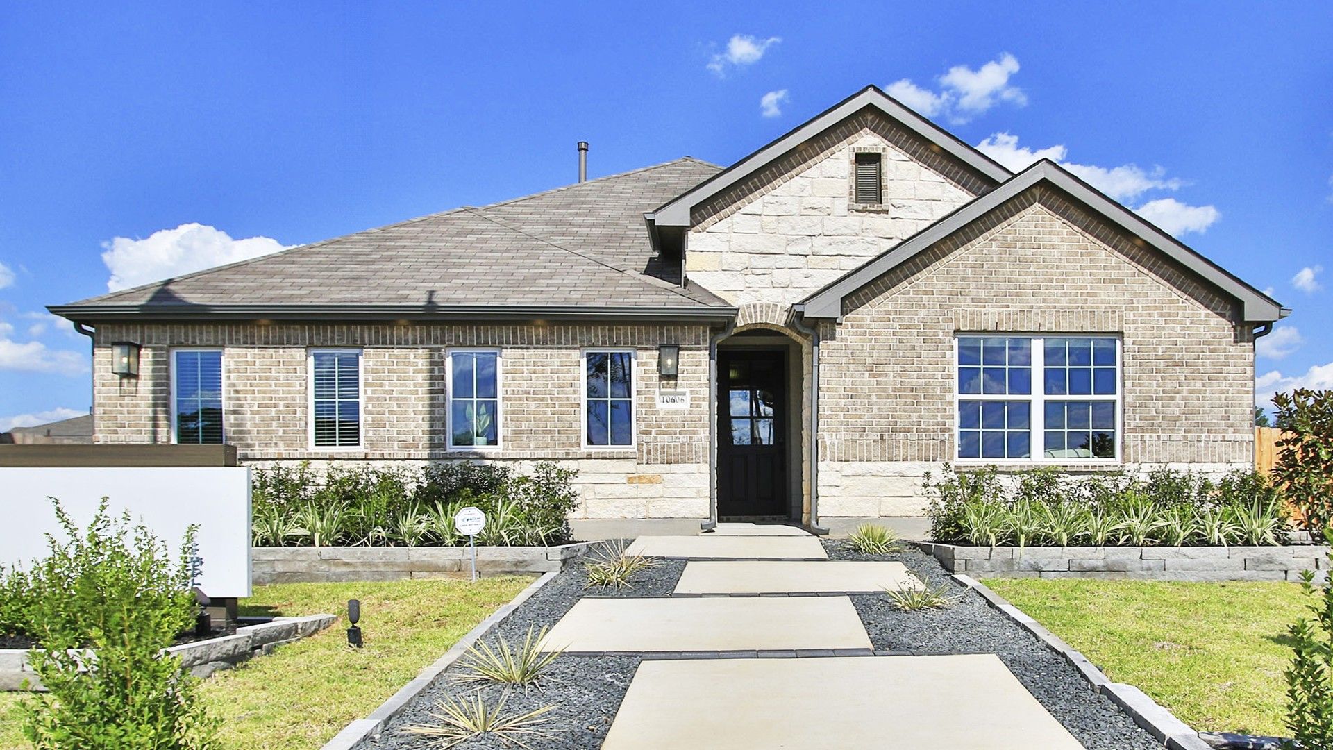 Elegant Brick House in Cielo Community with Gable Roof and Large Windows:Distinguished single-story home with refined brickwork and gable roofing in the exclusive Cielo enclave.