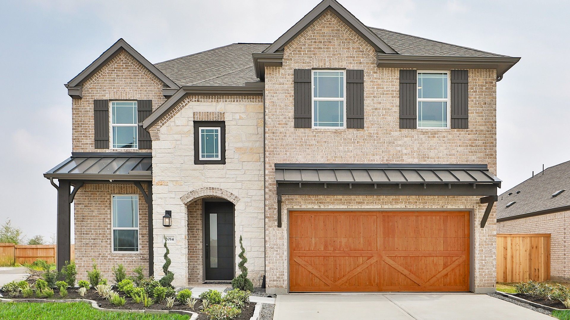 Brick Home with Wood Garage in Park at Eldridge:Elegant brick facade with wood garage, refined trim. Nestled in the desirable Park at Eldridge.
